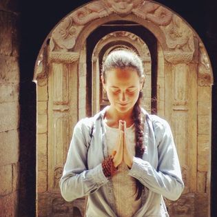 Patricia, your yoga teacher in Crete, is holding a mudra in a temple in Nepal